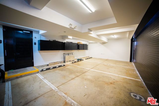 a room with gym equipment and a flat screen tv