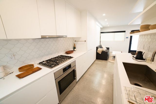 a kitchen with a sink a stove and a refrigerator