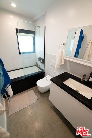 a living room with toilet and a couch