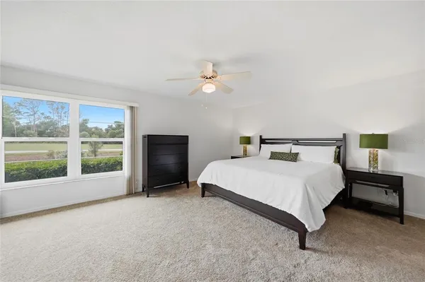 a bedroom with a large bed and a large window