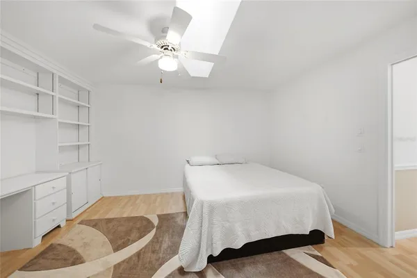 a bedroom with a bed and cabinet