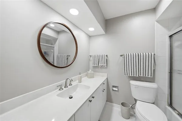 a bathroom with a toilet a sink a mirror and a toilet