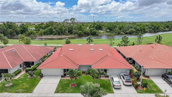 an aerial view of a house with garden space and a street view