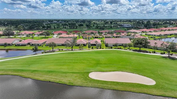 an aerial view of a houses with outdoor space and a lake view