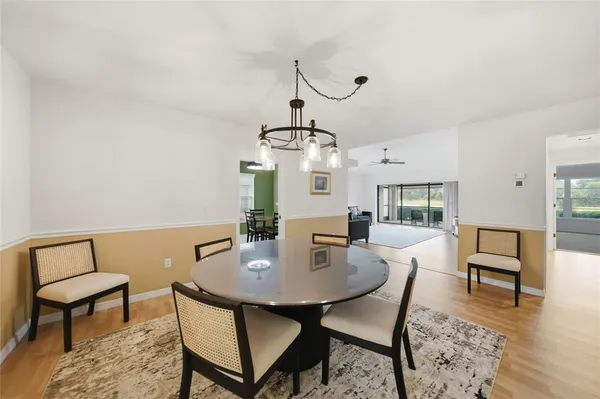 a view of a dining room with furniture and wooden floor