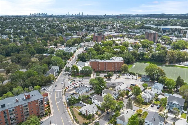 an aerial view of a house with a yard and lake view