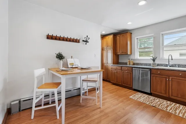a kitchen with a sink cabinets and wooden floor