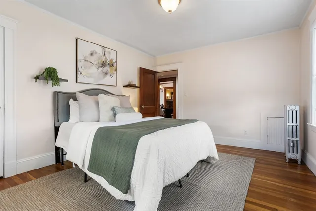 a bedroom with a bed and a painting on the wall