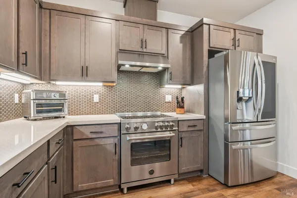 a kitchen with appliances cabinets and a counter top space
