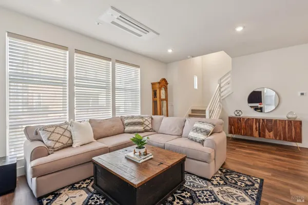 a living room with furniture and wooden floor