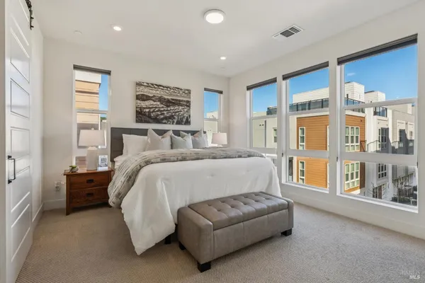 a spacious bedroom with a bed and a large window