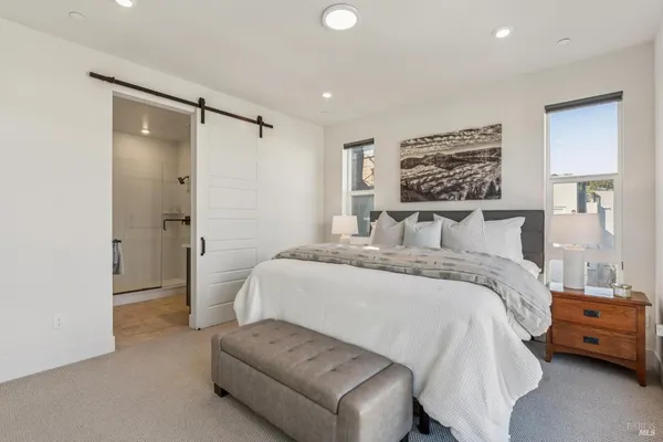 a bedroom with a bed and a painting on the wall