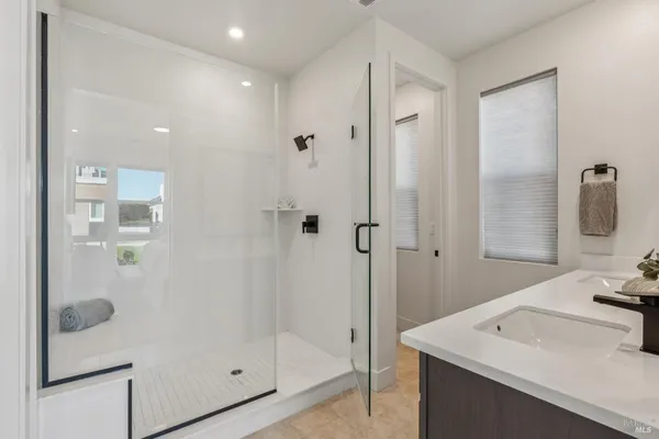 a bathroom with a sink a mirror and shower