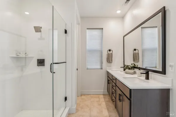 a bathroom with a double vanity sink mirror and double