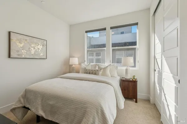 a bedroom with a bed and a large window