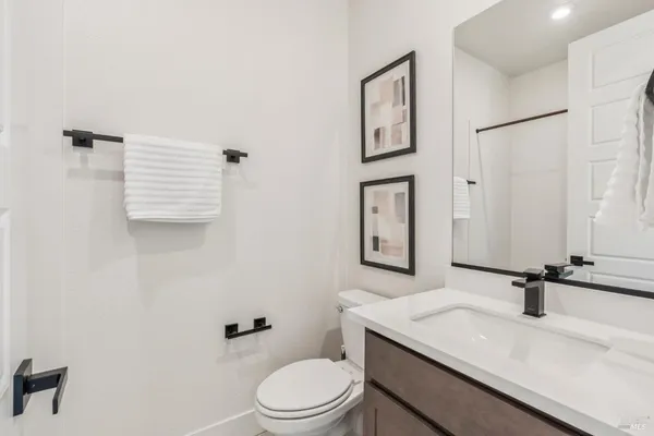 a bathroom with a sink a toilet and mirror