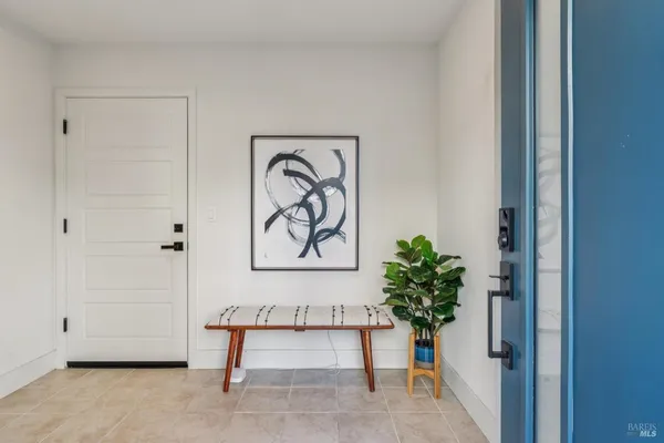 a view of entryway with paintings on the wall