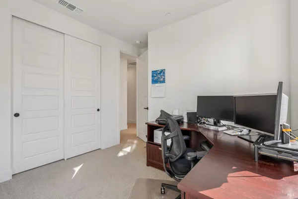a view of a workspace with furniture and a bathroom