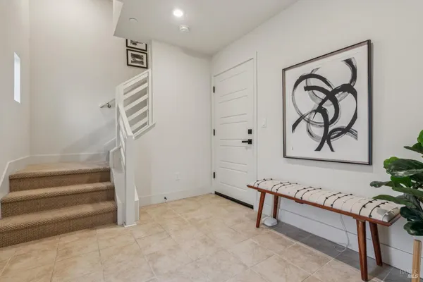 a view of entryway with stairs and a rug