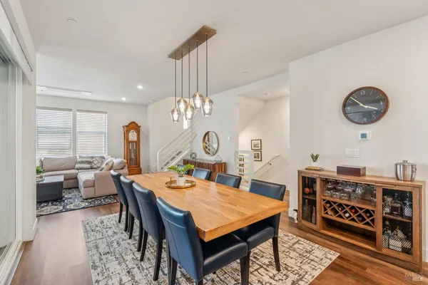 a view of a dining room with furniture a chandelier and wooden floor