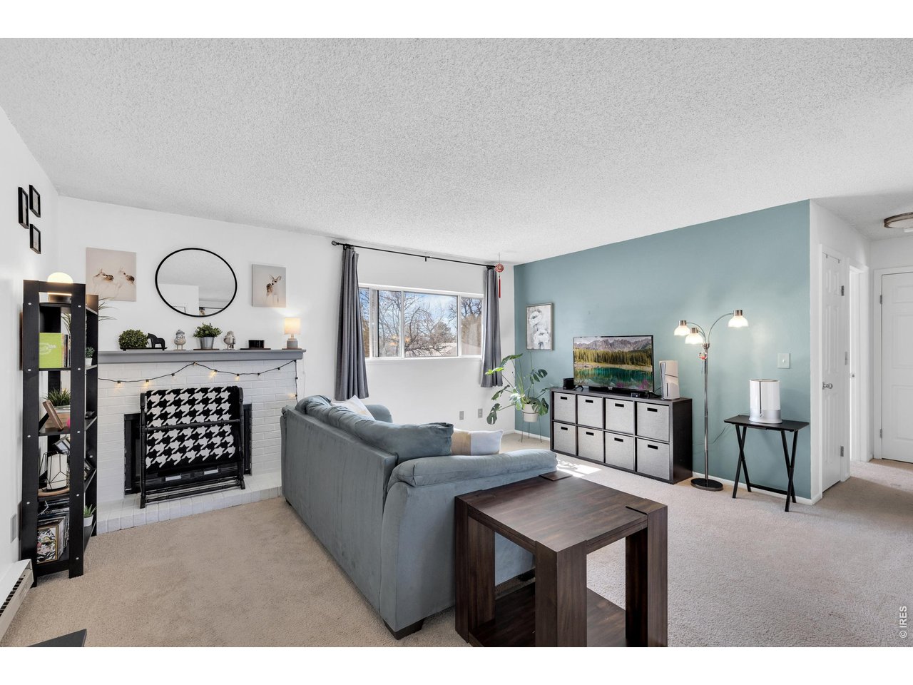 1024 East Swallow Road, Unit 234 Fort Collins, CO 80525 - Photo 1 of 21 a living room with furniture a flat screen tv and kitchen view