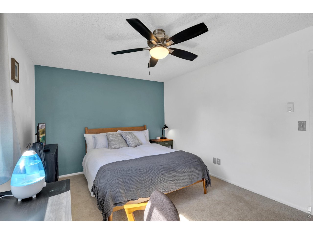 1024 East Swallow Road, Unit 234 Fort Collins, CO 80525 - Photo 11 of 21 a bedroom with a bed and a ceiling fan