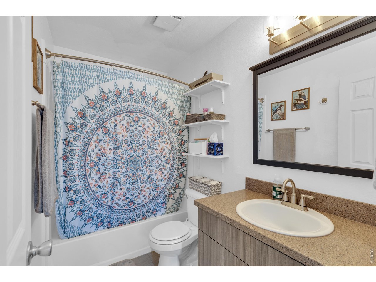 1024 East Swallow Road, Unit 234 Fort Collins, CO 80525 - Photo 15 of 21 a bathroom with a toilet sink and mirror