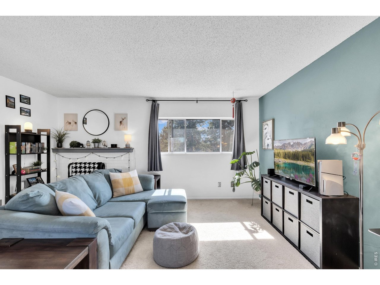 1024 East Swallow Road, Unit 234 Fort Collins, CO 80525 - Photo 3 of 21 a living room with furniture and a flat screen tv