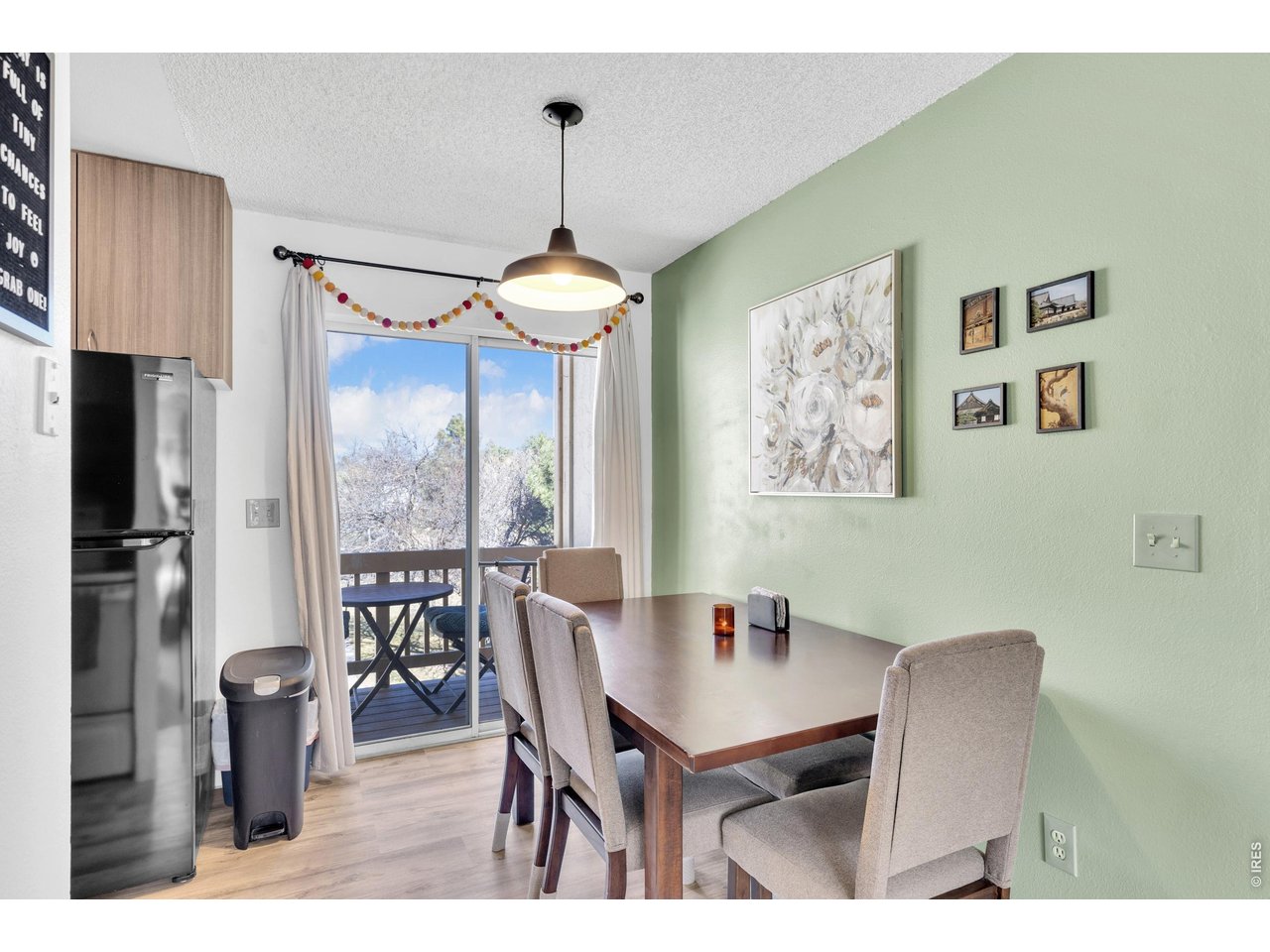 1024 East Swallow Road, Unit 234 Fort Collins, CO 80525 - Photo 5 of 21 a view of a dining room with furniture window and wooden floor