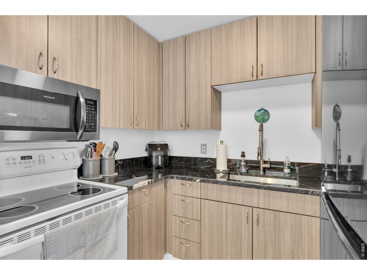 1024 East Swallow Road, Unit 234 Fort Collins, CO 80525 - Photo 7 of 21 a kitchen with stainless steel appliances granite countertop a sink stove and microwave