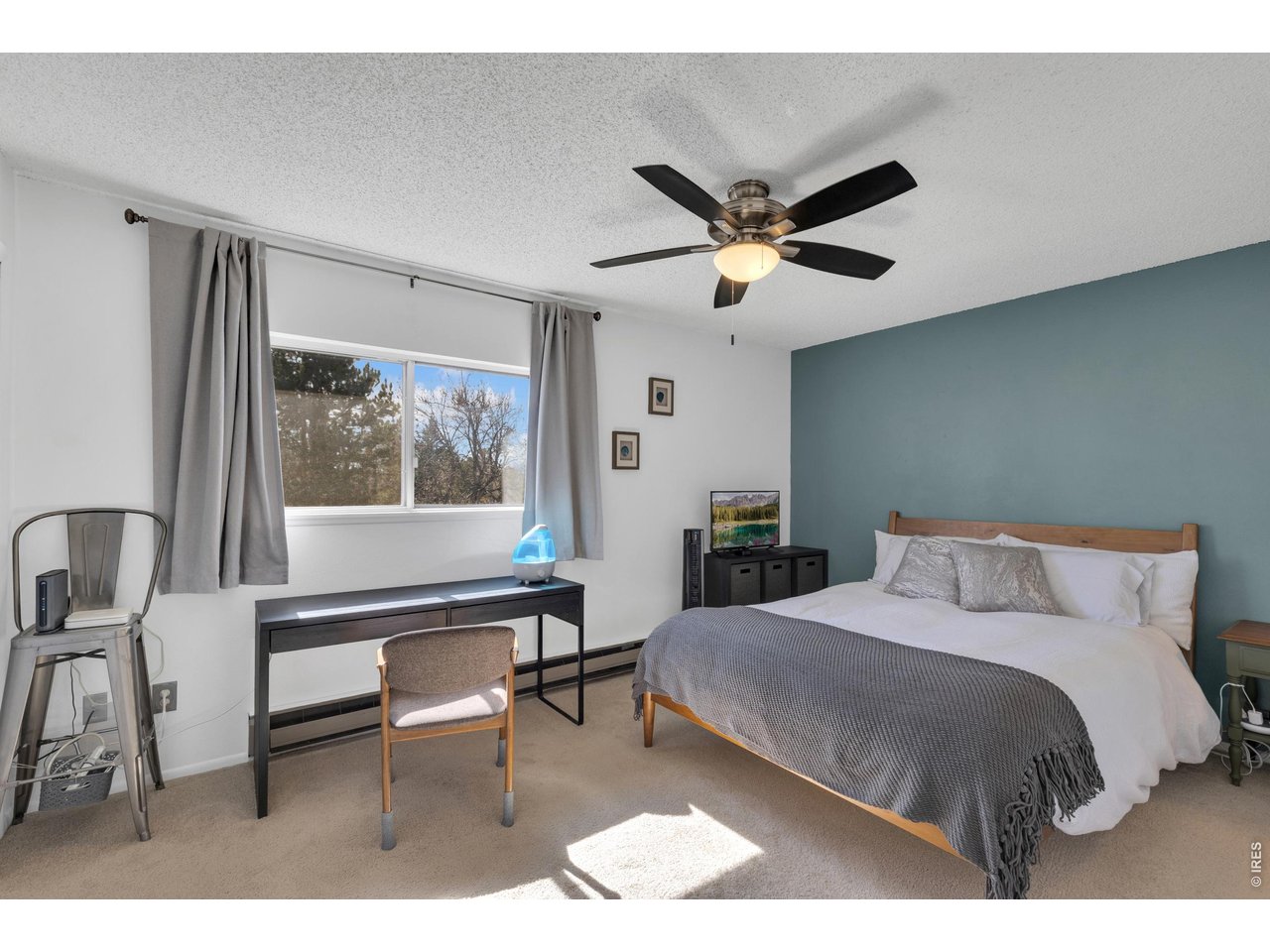 1024 East Swallow Road, Unit 234 Fort Collins, CO 80525 - Photo 9 of 21 a bedroom with a bed a desk and a painting on the wall