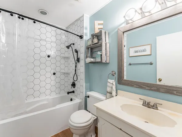 a bathroom with a sink a toilet and a bathtub