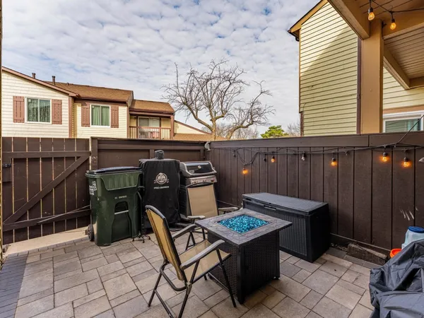 a view of a patio with table and chairs with wooden floor