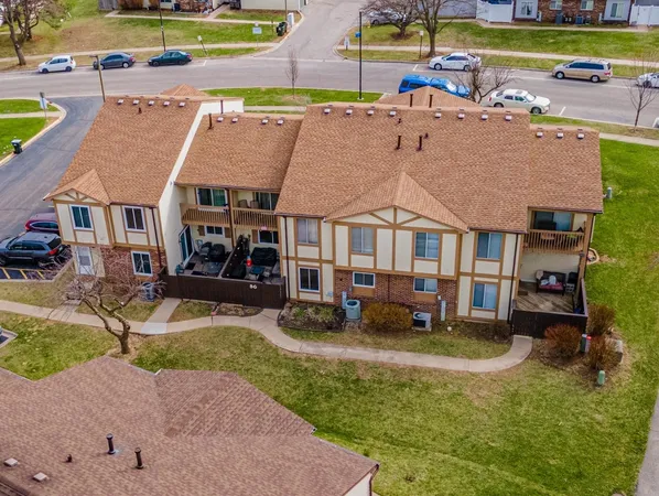 a aerial view of a house with a big yard and swimming pool