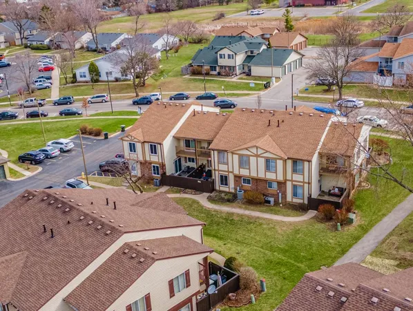 an aerial view of a house with swimming pool and a yard
