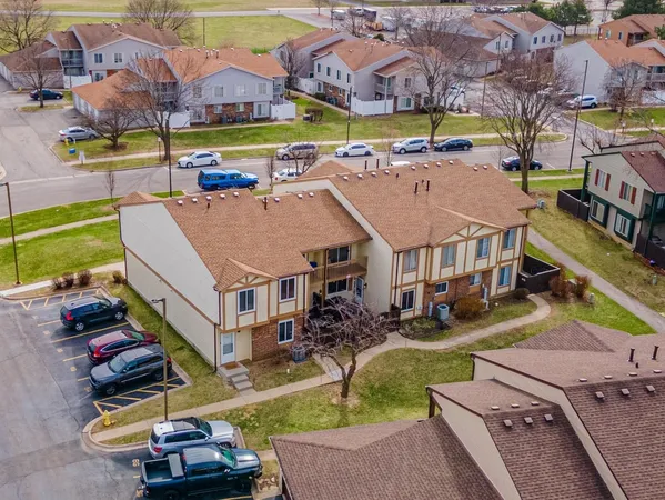 an aerial view of a houses with a swimming pool and outdoor seating