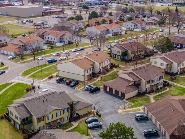 an aerial view of a house with a swimming pool yard and outdoor seating