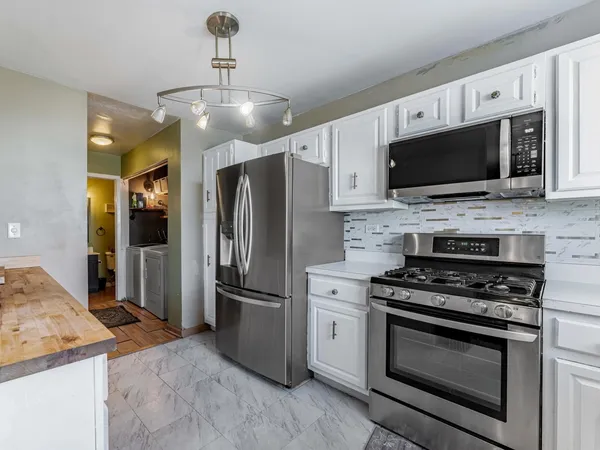 a kitchen with a sink stove and refrigerator