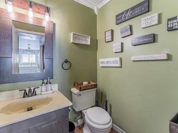 a bedroom with a bed a couch and a flat screen tv