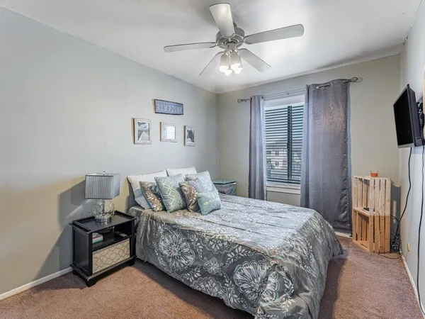 a bedroom with a bed mirror and window