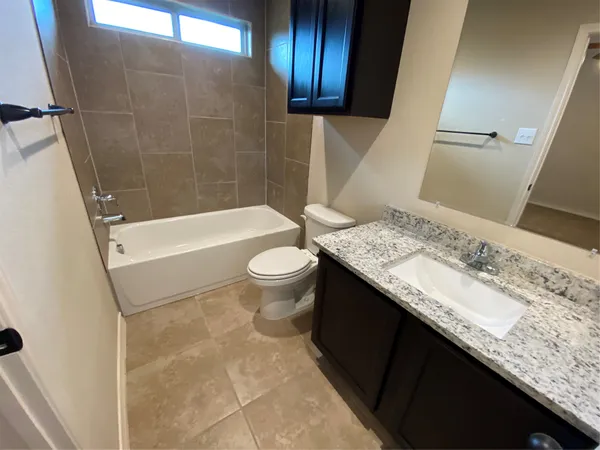a bathroom with a sink mirror and toilet