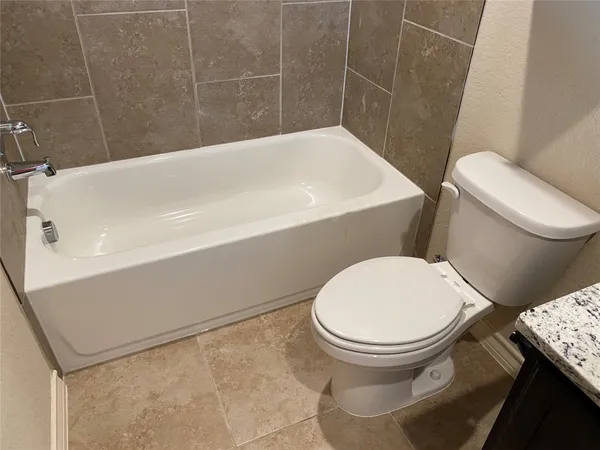 a bathroom with a toilet and a mirror