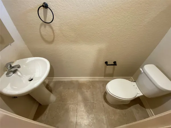 a bathroom with a sink toilet and mirror