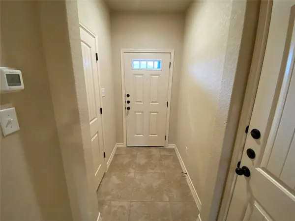 a view of a hallway with wooden floor and closet area