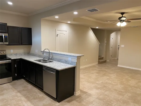 a kitchen with a sink and a refrigerator