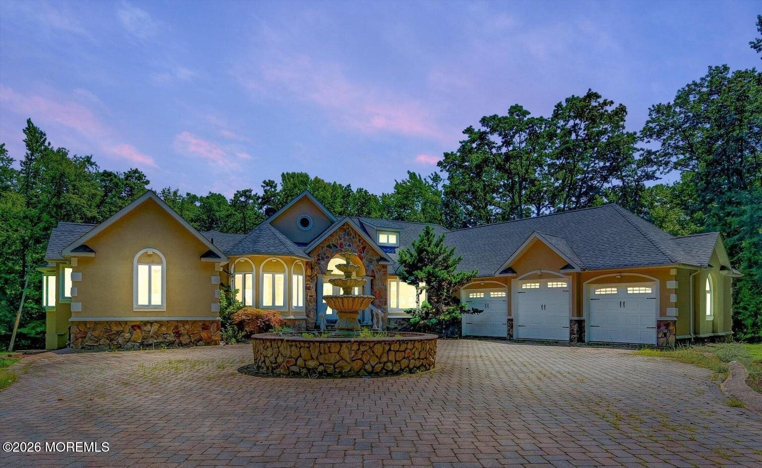 a front view of a house with a garden and a yard