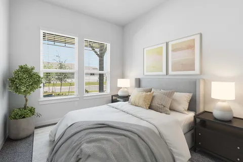 a bedroom with bed and a large window