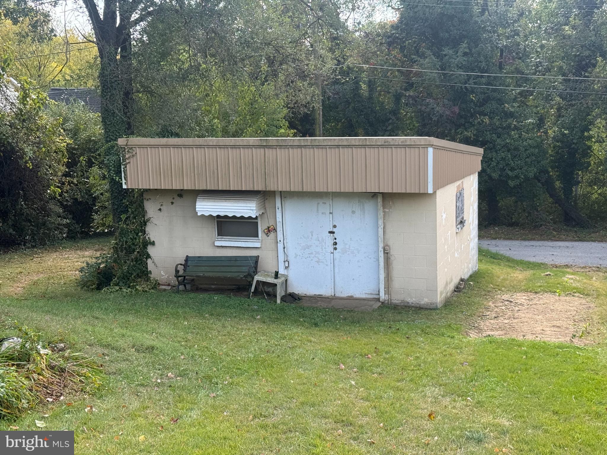 111 Ridge Avenue Baltimore, MD 21227 - Photo 2 of 10 Charming shed nestled in lush greenery.