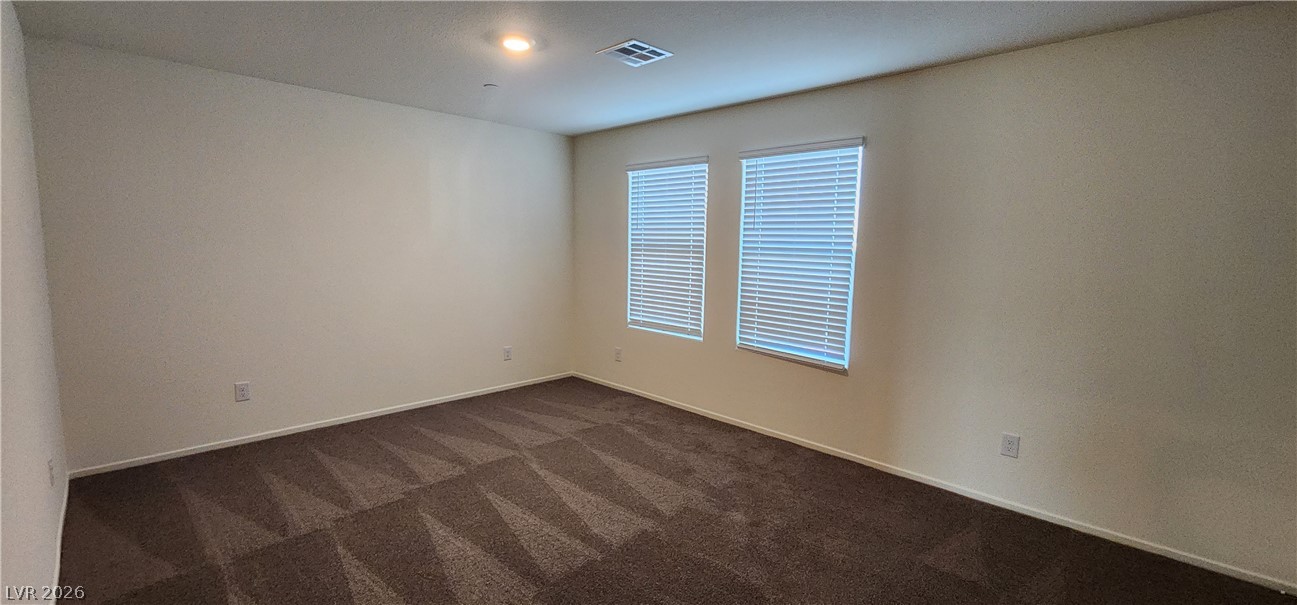 9127 Rory Storm Street Las Vegas, NV 89113 - Photo 13 of 27 Plush carpeting and natural light define this versatile bedroom space.
