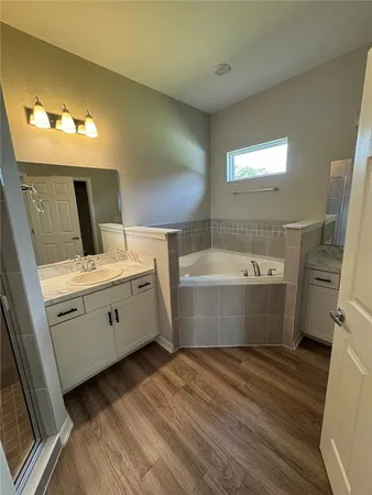 a view of a bathroom with a tub sink and mirror